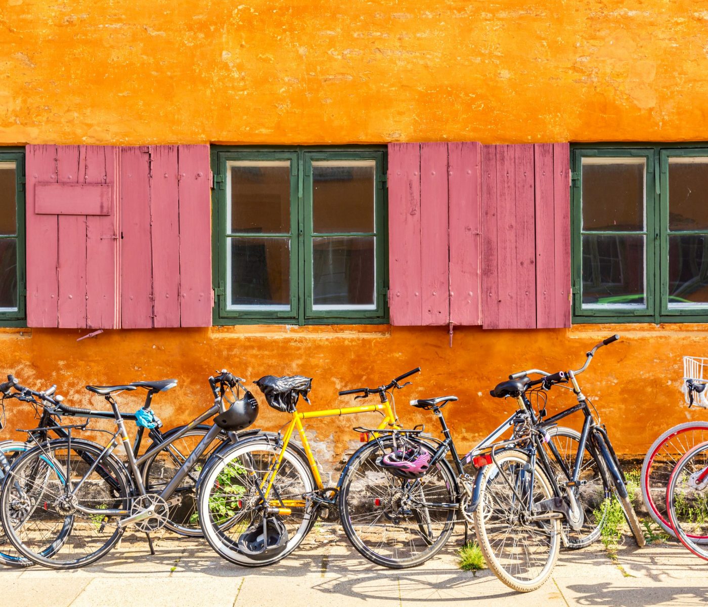 Old yellow house of Nyboder district with bikes. Old Medieval district in Copenhagen, Denmark. Picturesque of Copenhagen